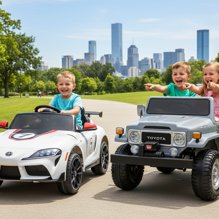 Kids riding Toyota GR Supra GT4 and Toyota Land Cruiser 24V 4x4 electric ride-on cars at a park with a city background