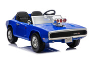 A blue toy muscle car ride-on with black seats, a clear windshield, chrome-style wheels, and a front grille badge reading 'Charger Rugged', shown on a white studio background.