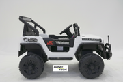 A white and black kids' electric ride-on toy jeep with large off-road tires, a steering wheel, and decorative decals, shown against a light gray studio background.