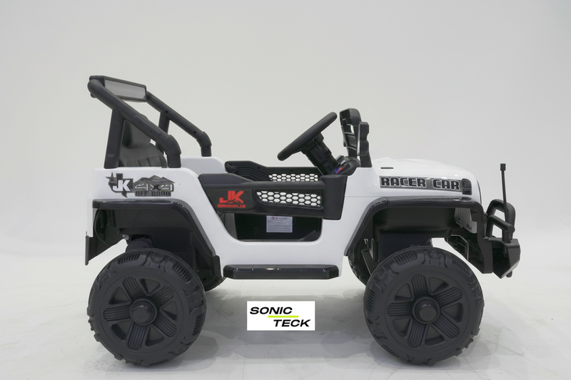 A white and black kids' electric ride-on toy jeep with large off-road tires, a steering wheel, and decorative decals, shown against a light gray studio background.
