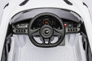 McLaren 765LT 12V Kids Ride-On Car in white with rubber tires, leather seat, LED lights, butterfly doors, parental remote control, and rechargeable battery.