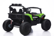 A green and black 4-seat electric ride-on UTV toy with large off-road tires, shown from a three-quarter rear angle on a white background.