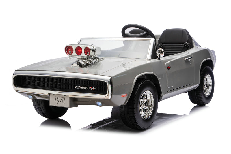A silver toy ride-on car styled like a 1970 Dodge Charger R/T, featuring a black convertible seat, a black steering wheel, a chrome-look hood scoop with red lights, and black tires, shown on a white background.