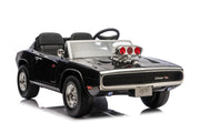 A black toy ride-on muscle car replica with chrome details, a raised engine hood, and a clear windshield, photographed on a white background.