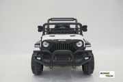 A white and black toy off-road vehicle designed like a Jeep, shown from the front on a light gray studio background. The vehicle features a black roll bar, black front bumper, black grille, and black tires, with a white hood and side panels.