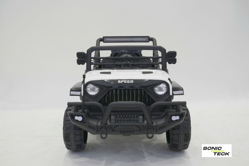 A white and black toy off-road vehicle designed like a Jeep, shown from the front on a light gray studio background. The vehicle features a black roll bar, black front bumper, black grille, and black tires, with a white hood and side panels.