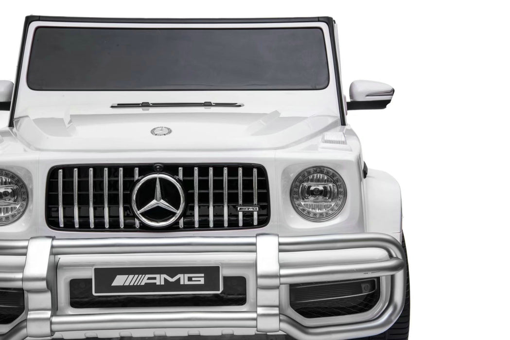 Mercedes G63 AMG 24V ride-on car for kids in black, officially licensed with rubber tires and LED lights.