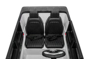 Interior of Mercedes G63 kids ride-on car showing dashboard, leather seats, seatbelts, and built-in music system.