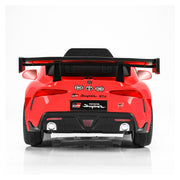 A red Toyota Supra GR licensed ride-on toy car shown from the rear, featuring a black spoiler, black bumper, and chrome exhaust details on a white studio background.