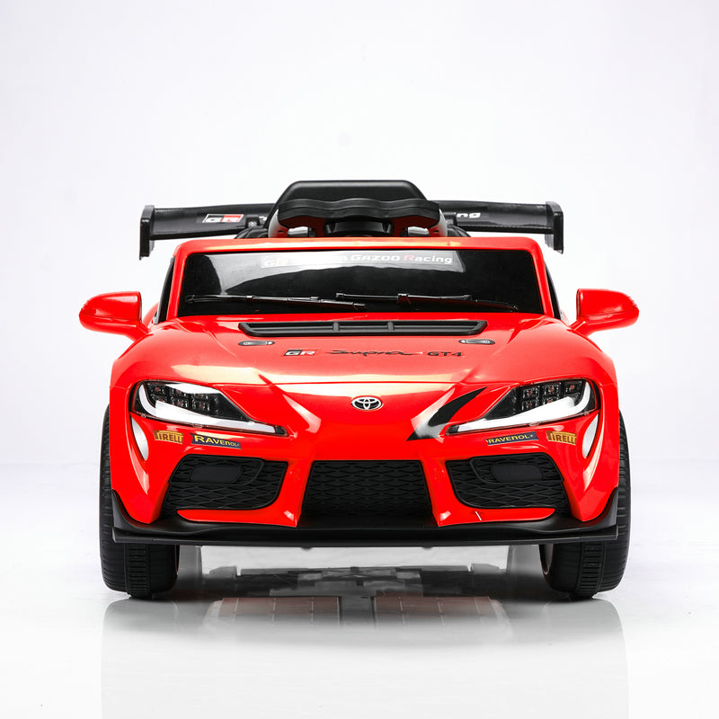 A red toy car styled like a Toyota Supra GT, photographed from the front on a clean white studio background.
