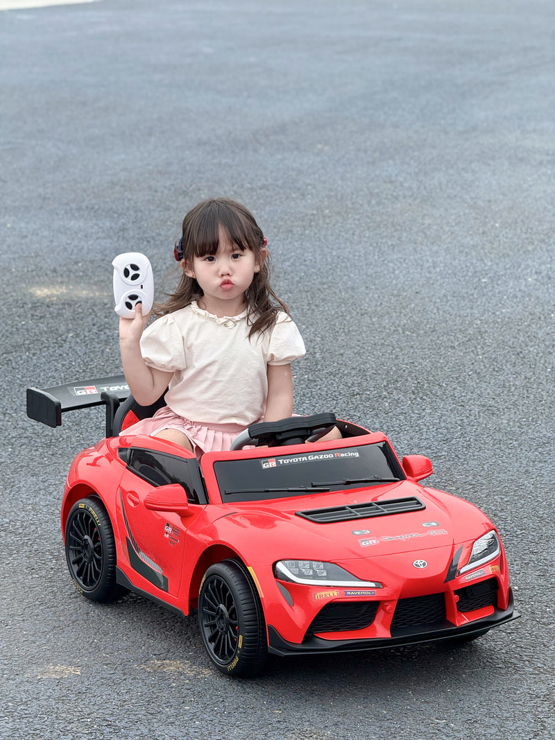 Red Colour Toyota GR Supra GT4 ride-on car with a big child inside