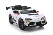 A white Toyota Supra GT-R licensed ride-on toy car with black and red racing decals, black wheels, and a black rear spoiler, shown on a white background.