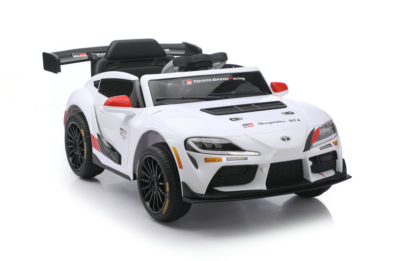 A white Toyota Supra GT-R licensed ride-on toy car with black and red racing decals, black wheels, and a black rear spoiler, shown on a white background.