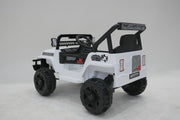 Toddler driving a white 12V ride-on Jeep Wrangler